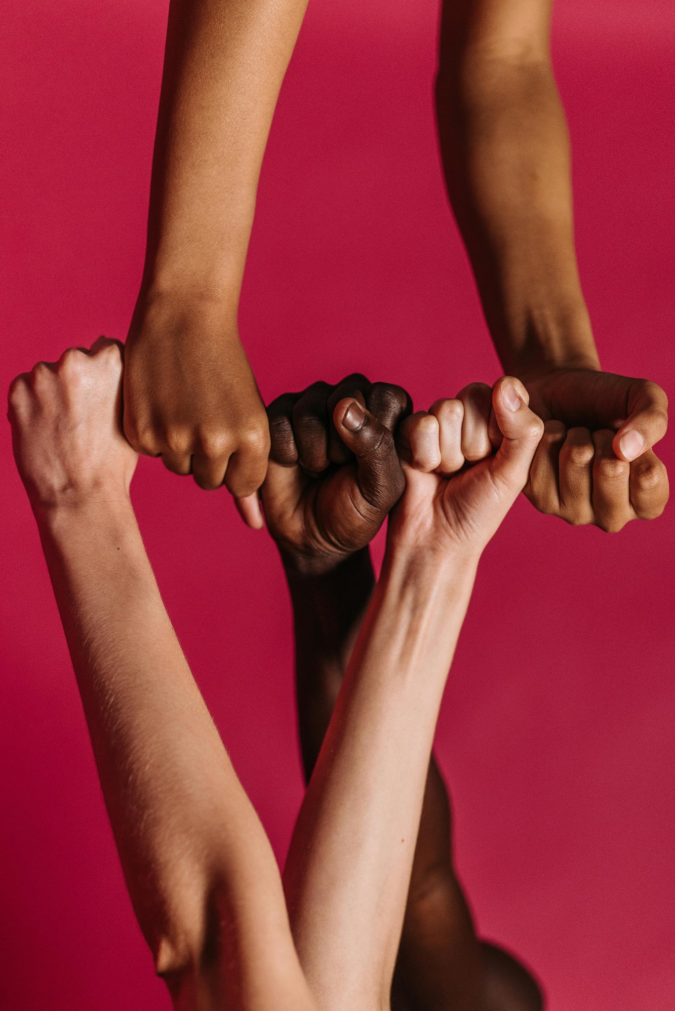 Diverse hands joined together in unity